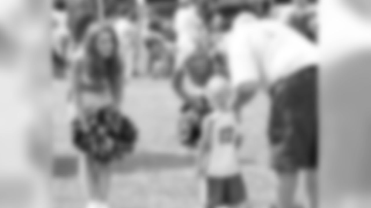 Young fan is greeted by Cheerleaders Tracey and Monica