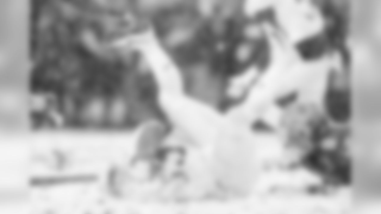 Army RB Darnell Woolfolk falls into a pile of snow.