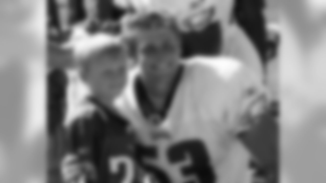 Rookie LB Andy Studebaker poses for a snapshot with this young fan