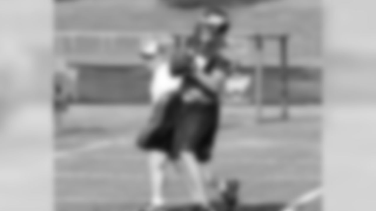 Second-year TE Brent Celek catches a pass despite pressure applied by coach Tom Melvin