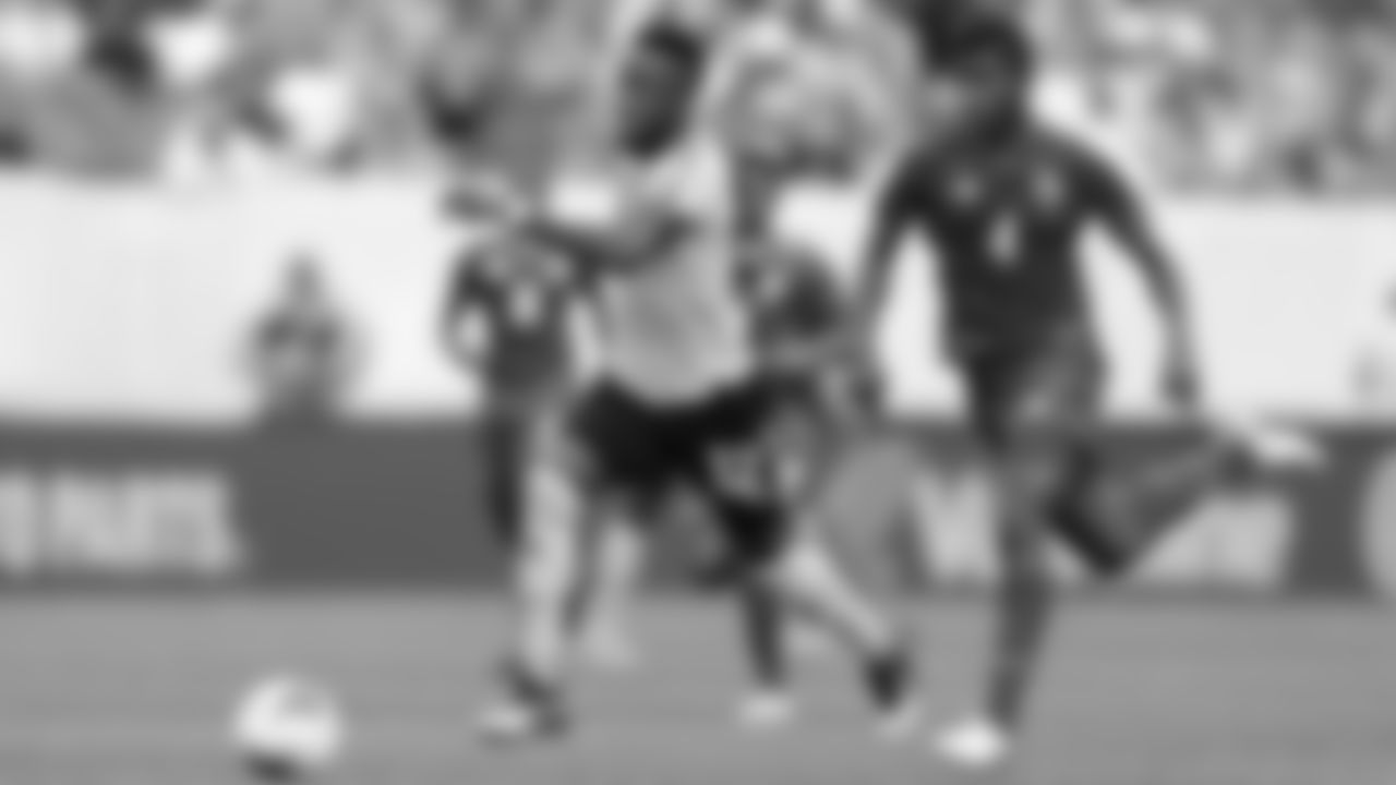 Jamaica's Junior Flemmings (left) moving the ball past Panama's Fidel Escobar