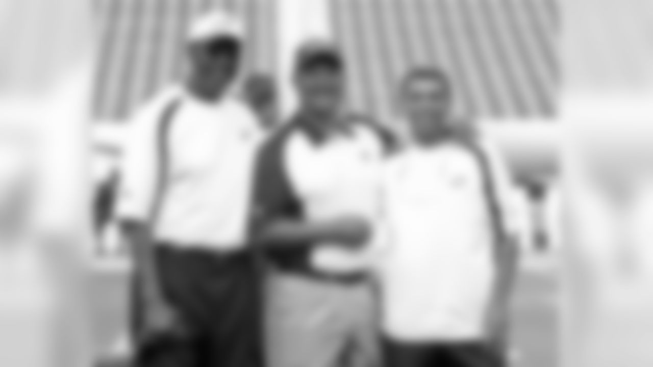 Harold Carmichael (left) and receivers coach David Culley (right) pose for a photo with a friend from the Browns