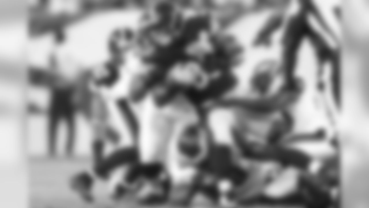Eagles defenders help each other bring down a Pittsburgh Steeler