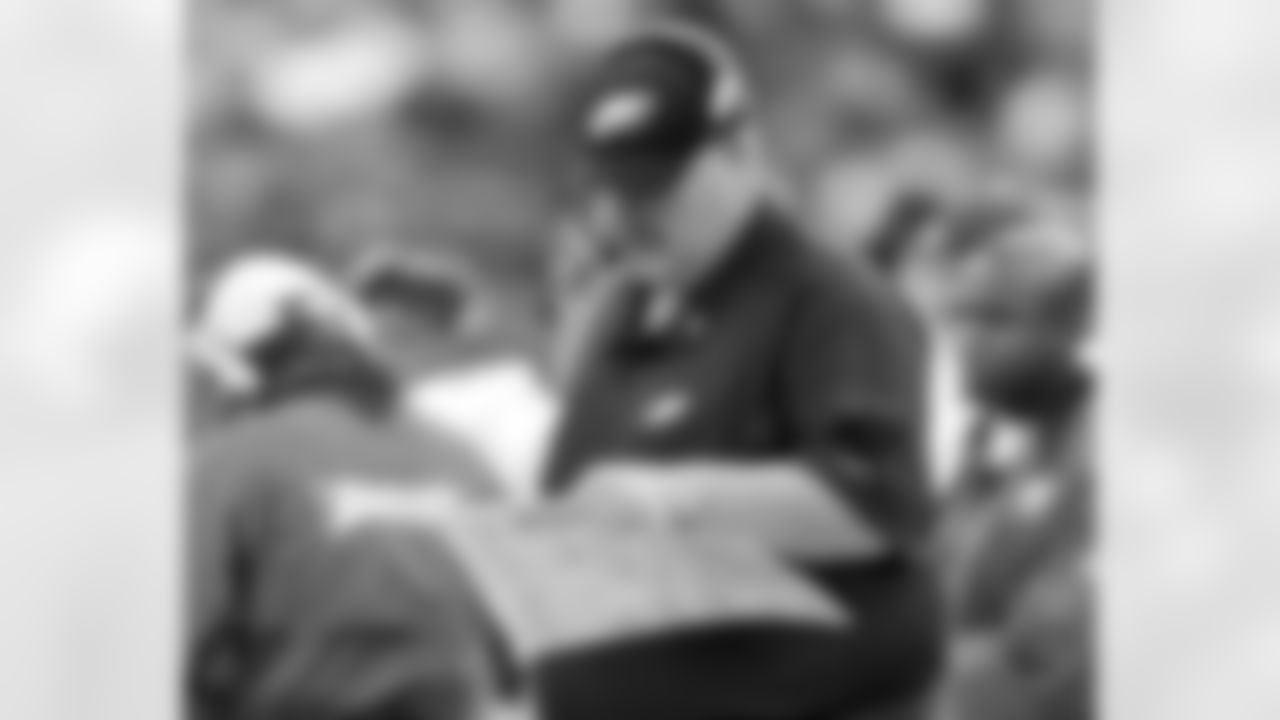 Head coach Andy Reid looks over his play sheet