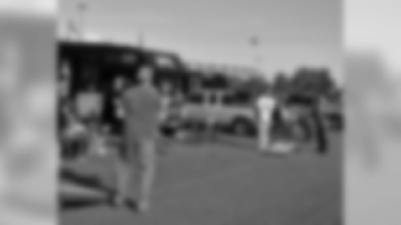 Fans play a game of tailgate toss