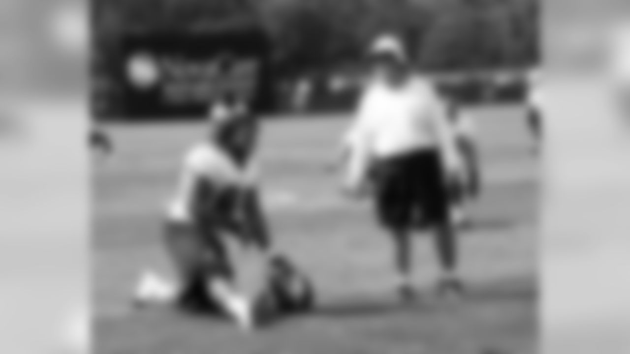 DT Trevor Laws and defensive line coach Pete Jenkins share a laugh during the post-practice stretch period