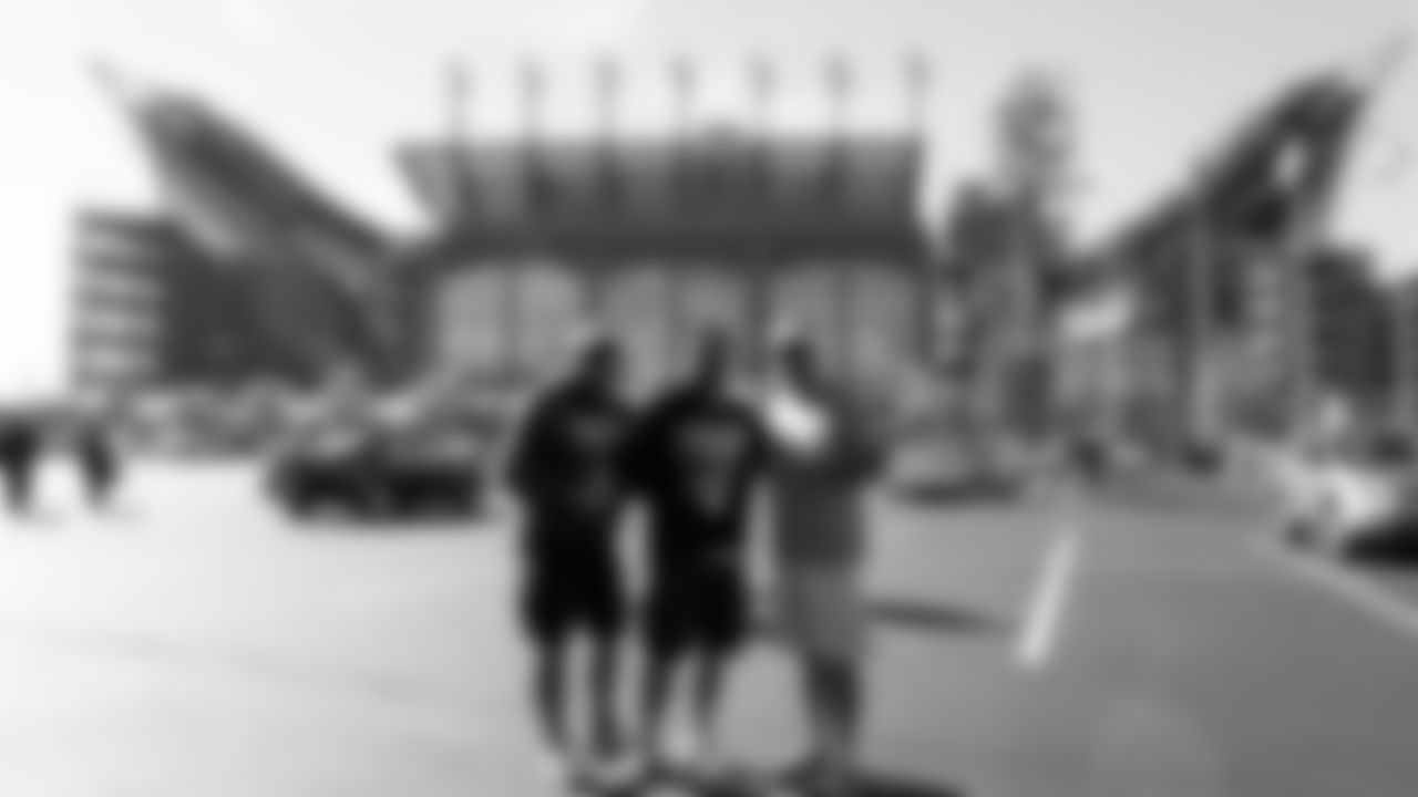 Three Eagles fans pose outside Lincoln Financial Field.