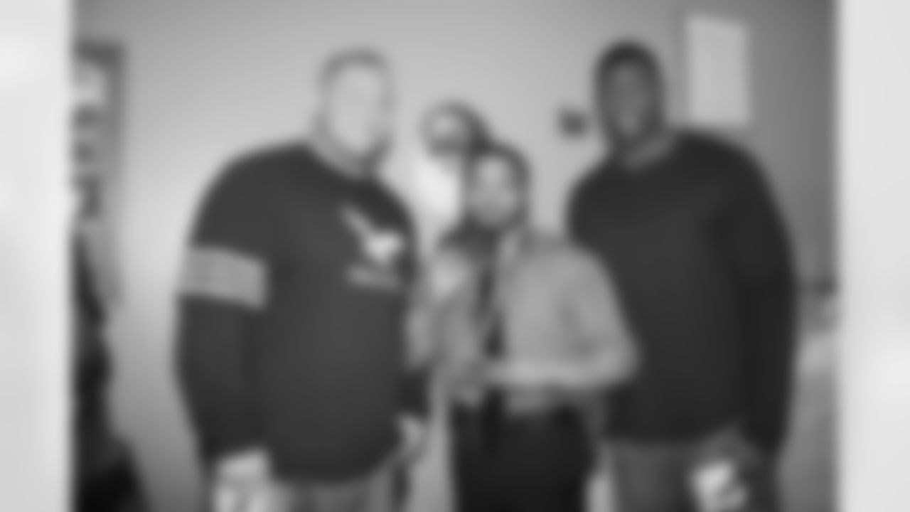 C Shipley and TE Ingram pose with residents