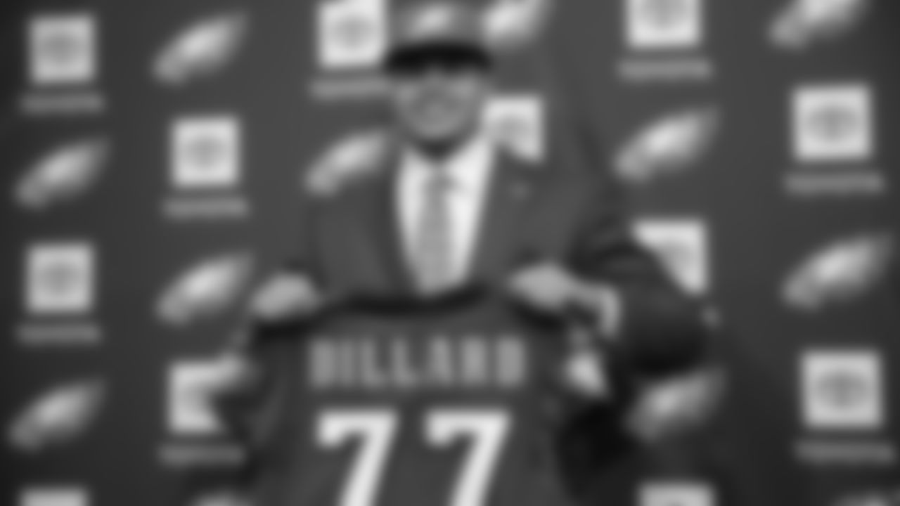 Andre Dillard holds up his jersey at his introductory press conference