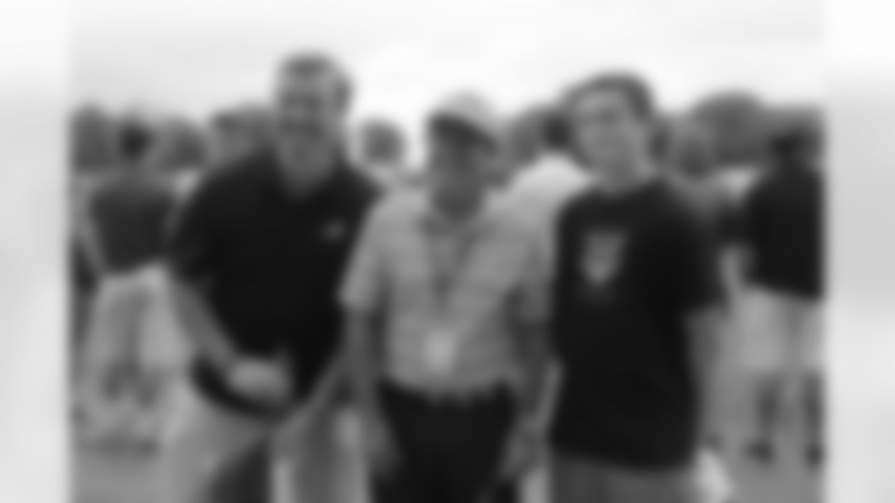 Fans pose with Eagles Broadcaster Merrill Reese