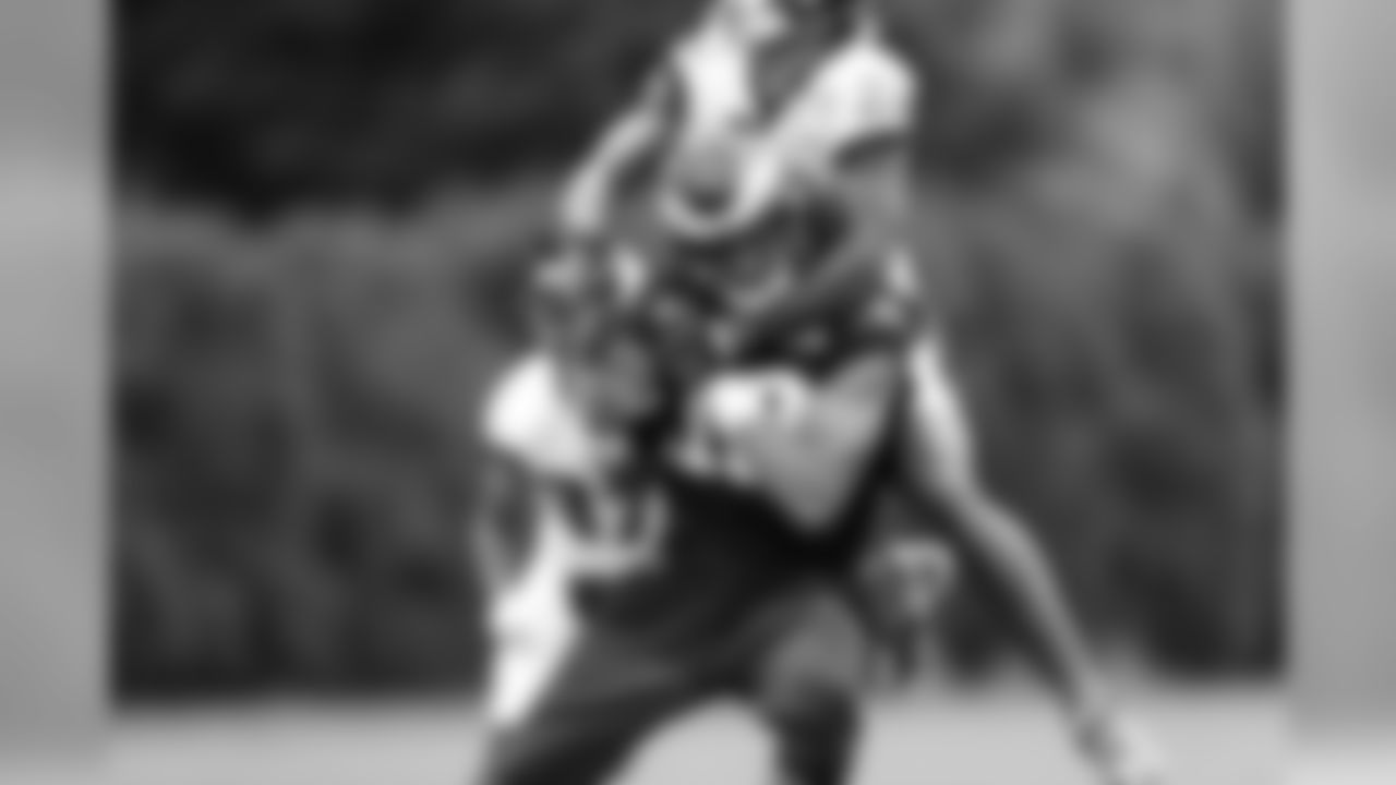 WR Mack Hollins fends off a defensive back to catch a pass