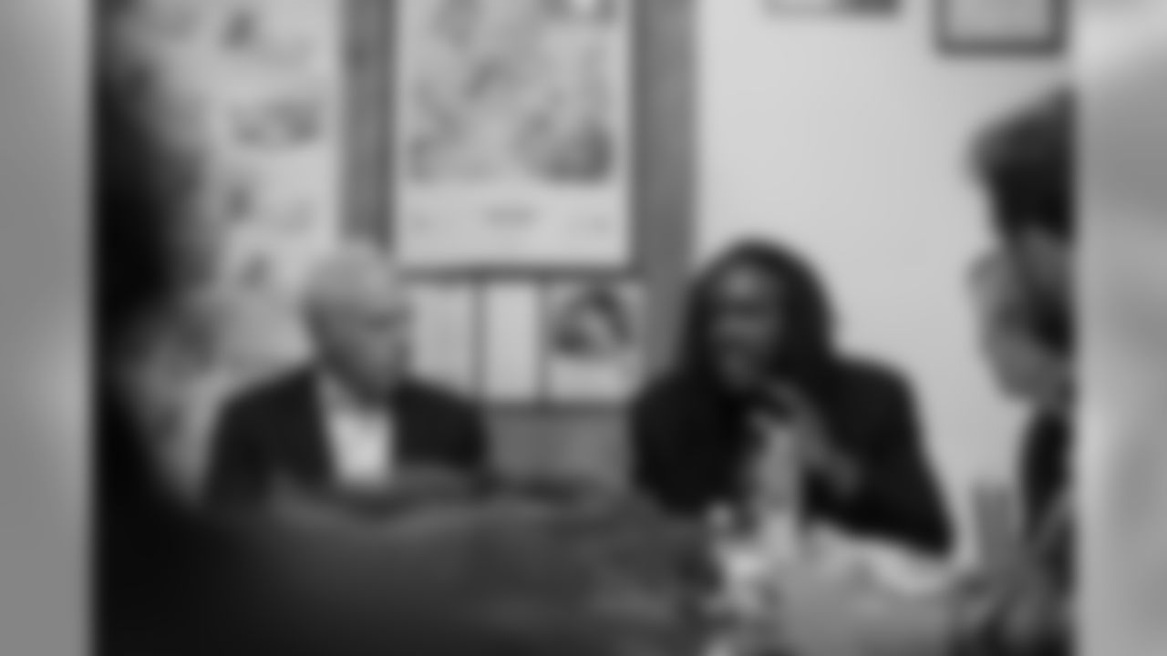 Lurie sits next to Jondhi Harrell, founder and executive director of The Center for Returning Citizens.