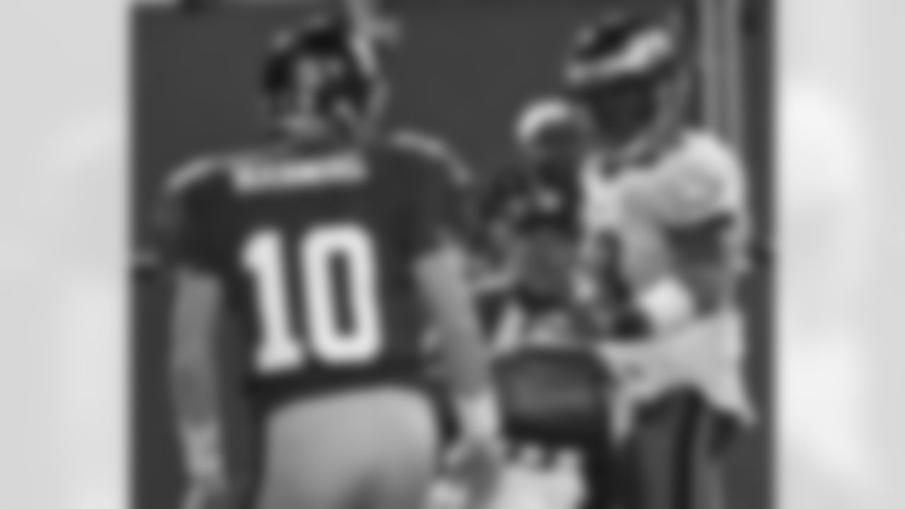 Trent Cole glances at QB Manning on his way into the end zone