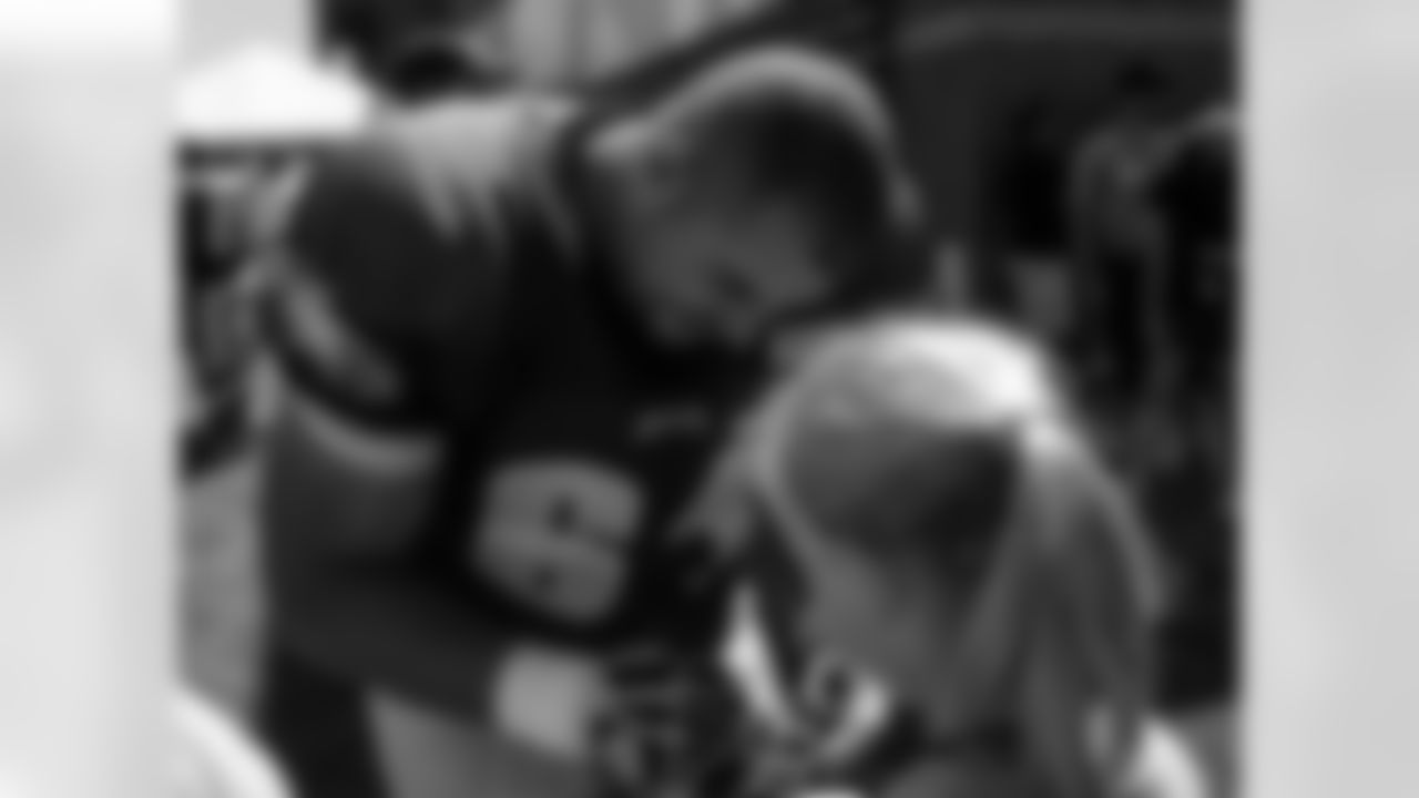 G/C Julian Vandervelde signs autographs for fans after Monday's practice