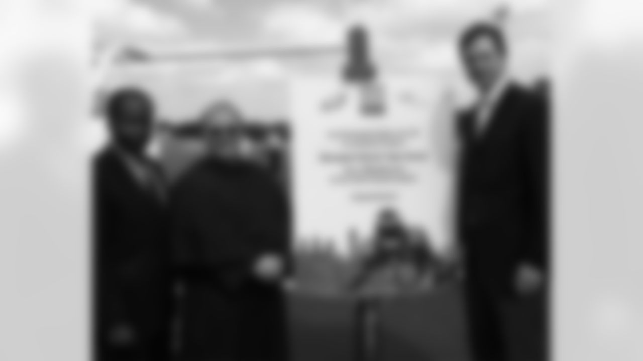 William Smith, chairman of the LISC (Local Initiatives Support Corporation) Local Advisory Board, poses for a photo with Father Joseph Esposito, principal of Monsignor Bonner HS, and Eagles' Senior VP Mark Donovan