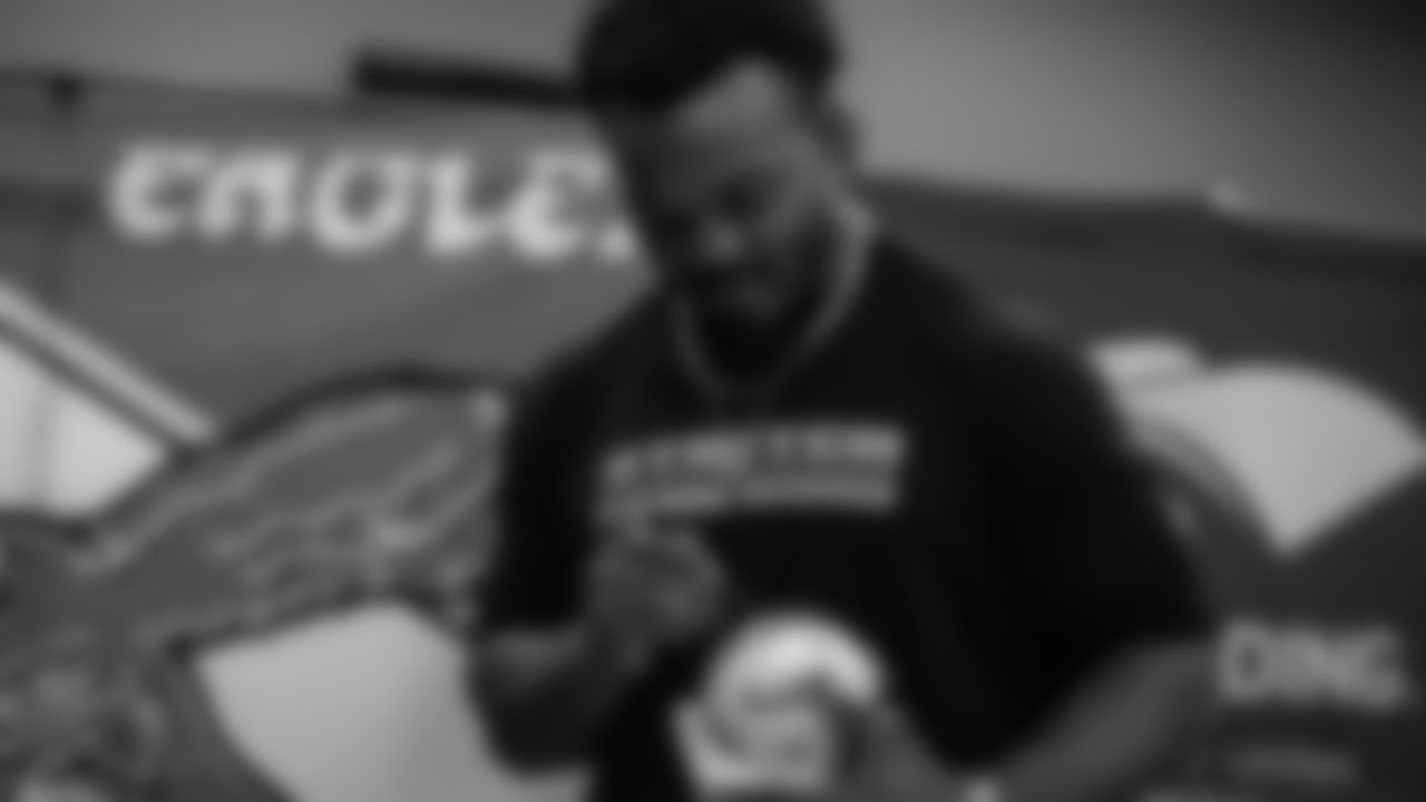 Dean signs a mini helmet.