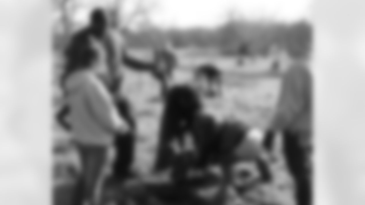 T Winston Justice helps plant one of the 60 trees that were bought by fans