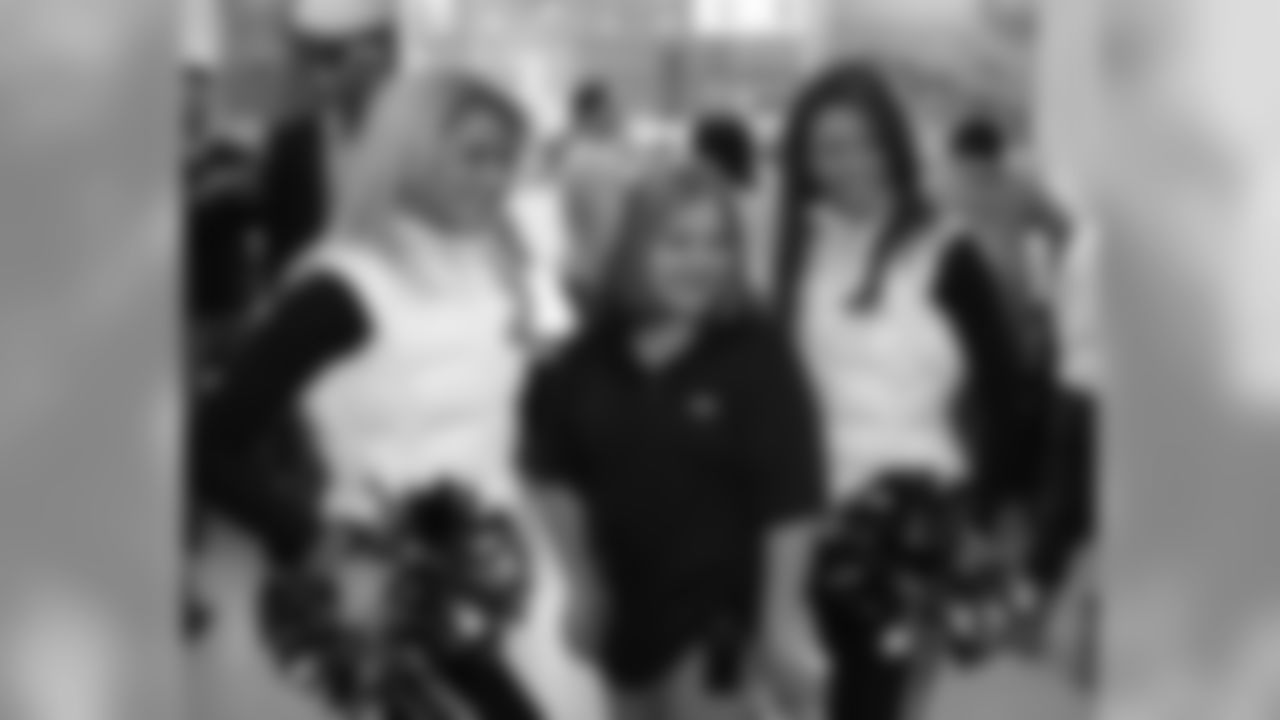 Eagles cheerleaders Marissa and Amanda pose for a photo with a fan