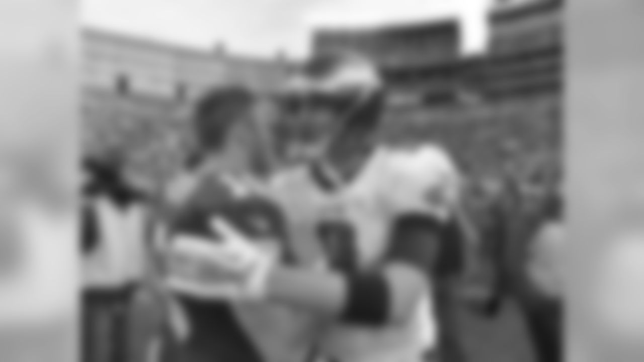 Philadelphia Eagles' QB Nick Foles hugs Green Bay Packers' QB Scott Tolzien after the game. The Eagles won 27-13.