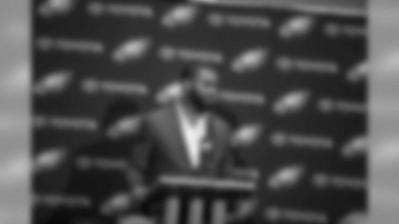 Taking questions at the podium