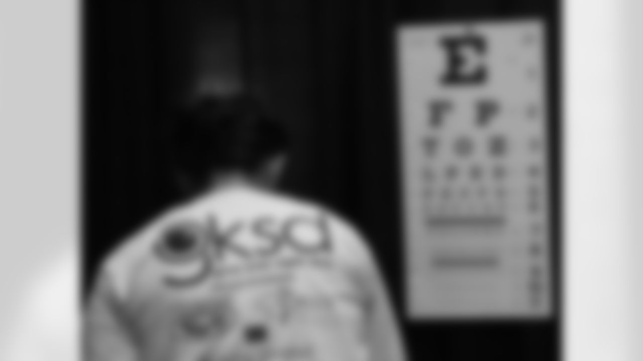 One of the volunteers sets up the eye chart