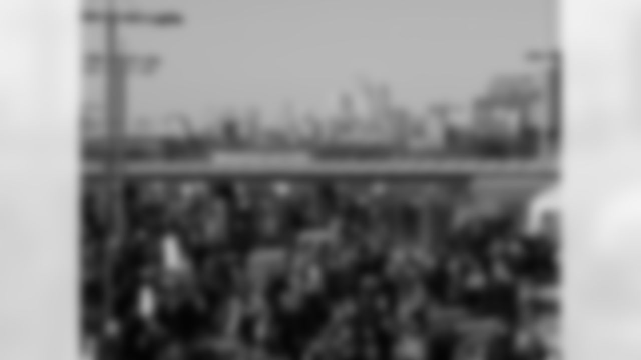 An awesome shot of Eagles fans coming out to a game with the city skyline in the background