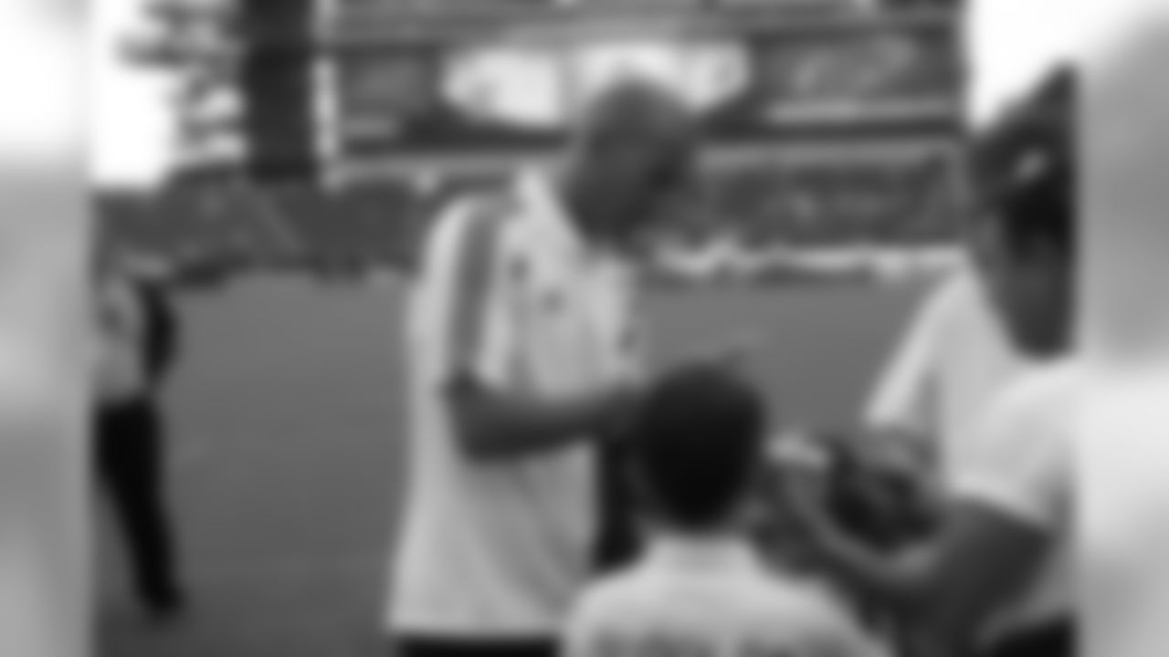 Real Madrid's director of football Zinedine Zidane, the former Fifa World Player of the Year, signs an autograph for a young fan.
