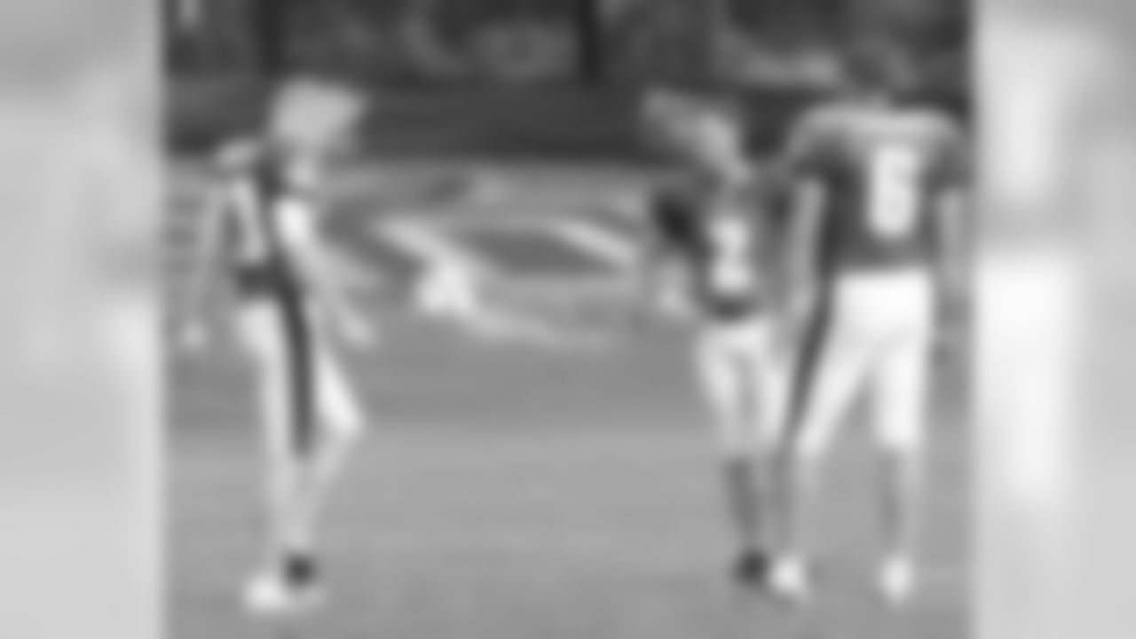 P Ken Parrish, K David Akers, and P Sav Rocca kick around with a soccer ball