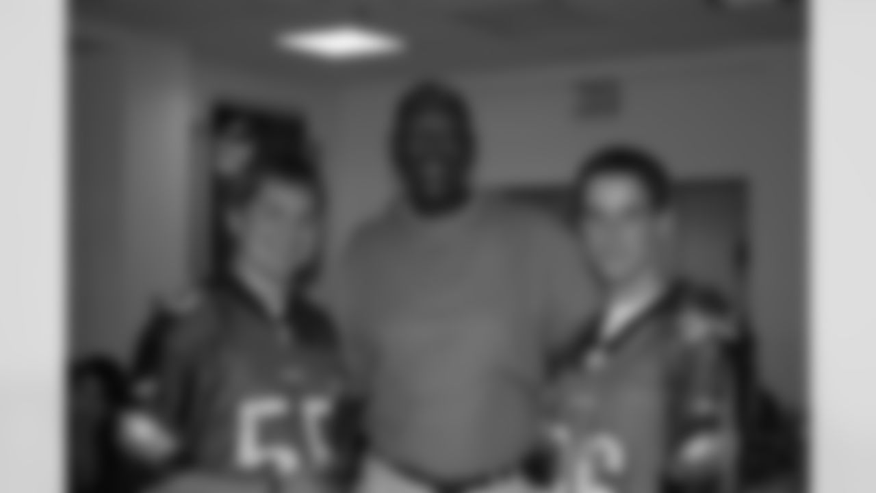 Harold poses with two passionate Eagles fans