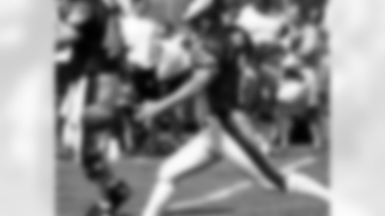 K David Akers practices punting