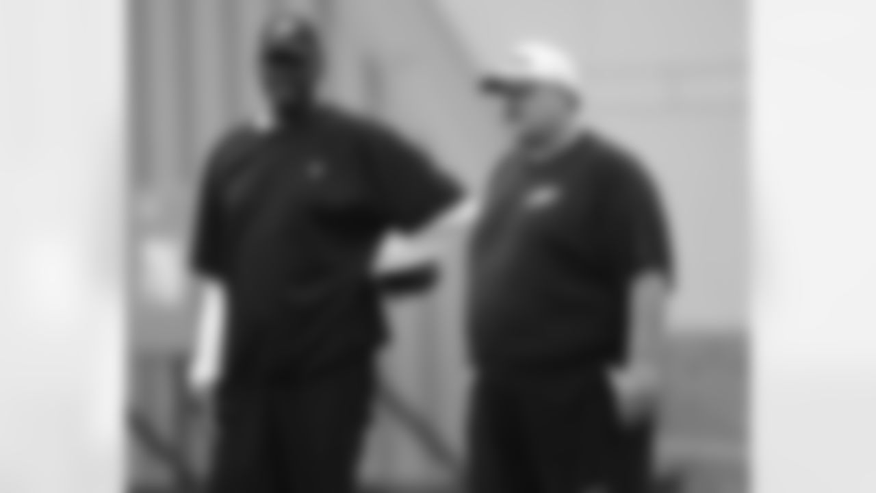 Director of player programs Harold Carmichael and head coach Andy Reid discuss the action