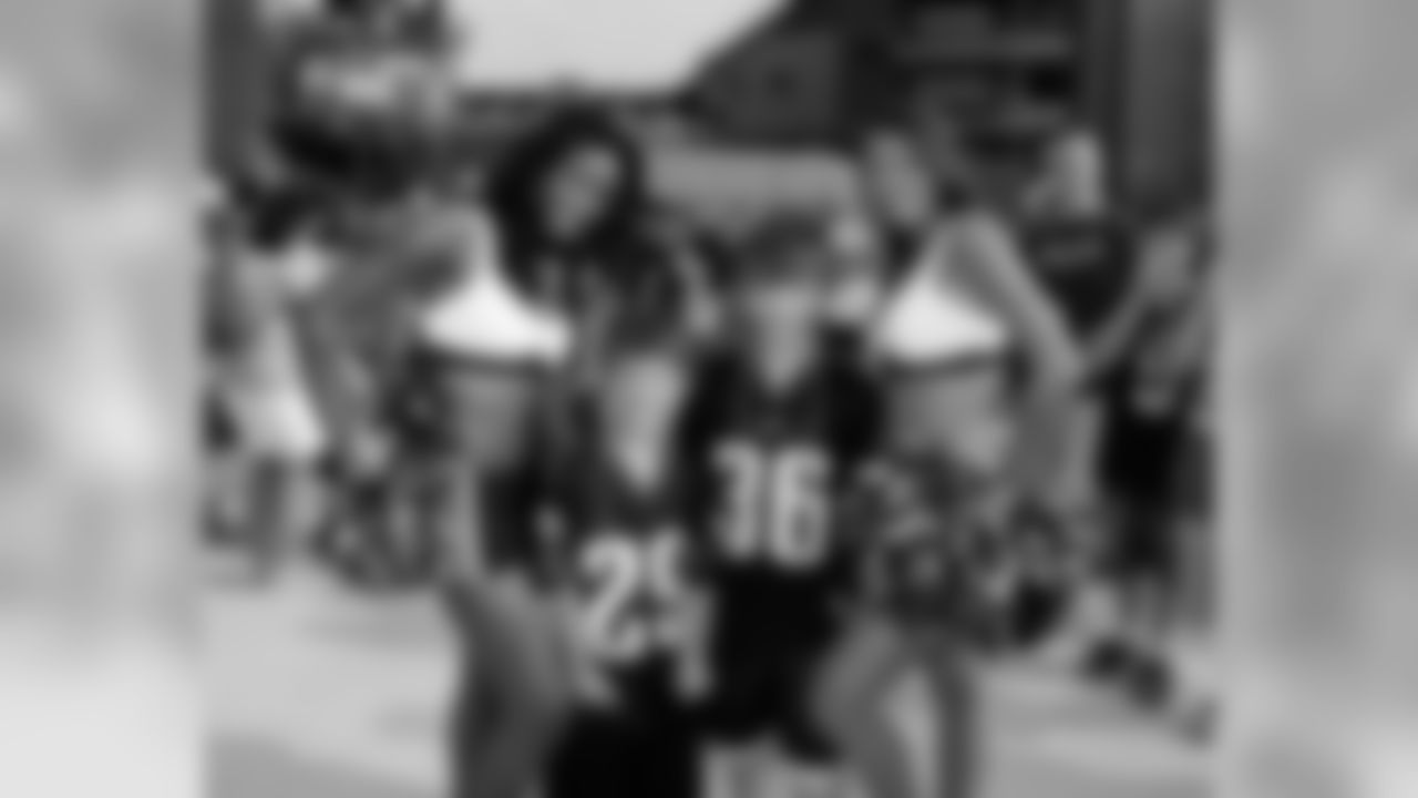 A pair of youngsters with a pair of Eagles Cheerleaders