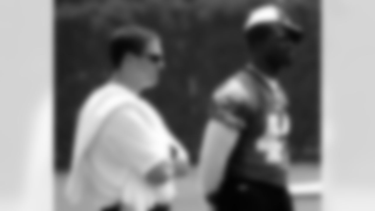 Assistant Athletic Trainer Chris Peduzzi and FB Thomas Tapeh watch from the sidelines