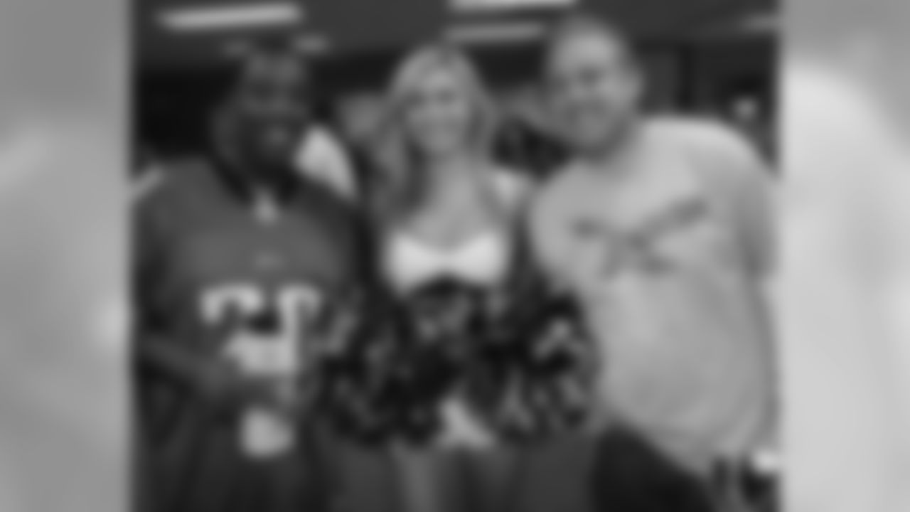 A pair of Teva Pharmaceuticals workers are all smiles in this photo with Cheerleader Monica