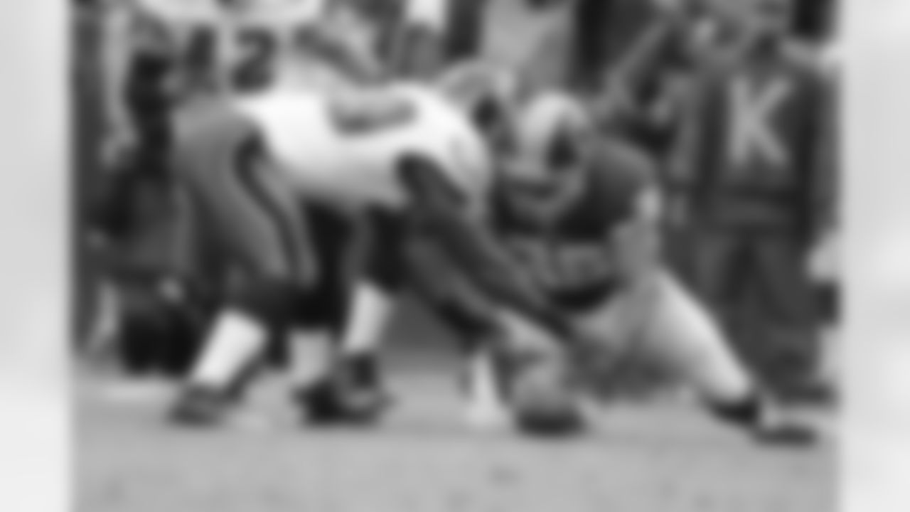 Players from both teams reach for the ball