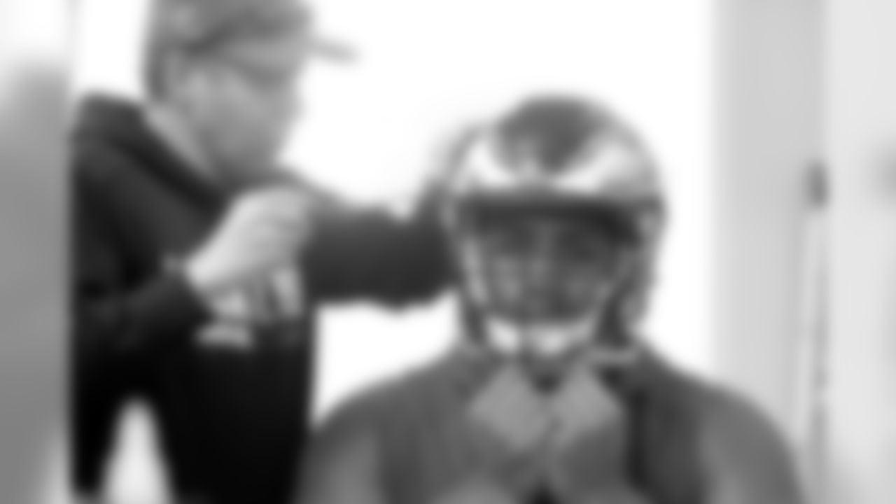 Mailata has his helmet adjusted.