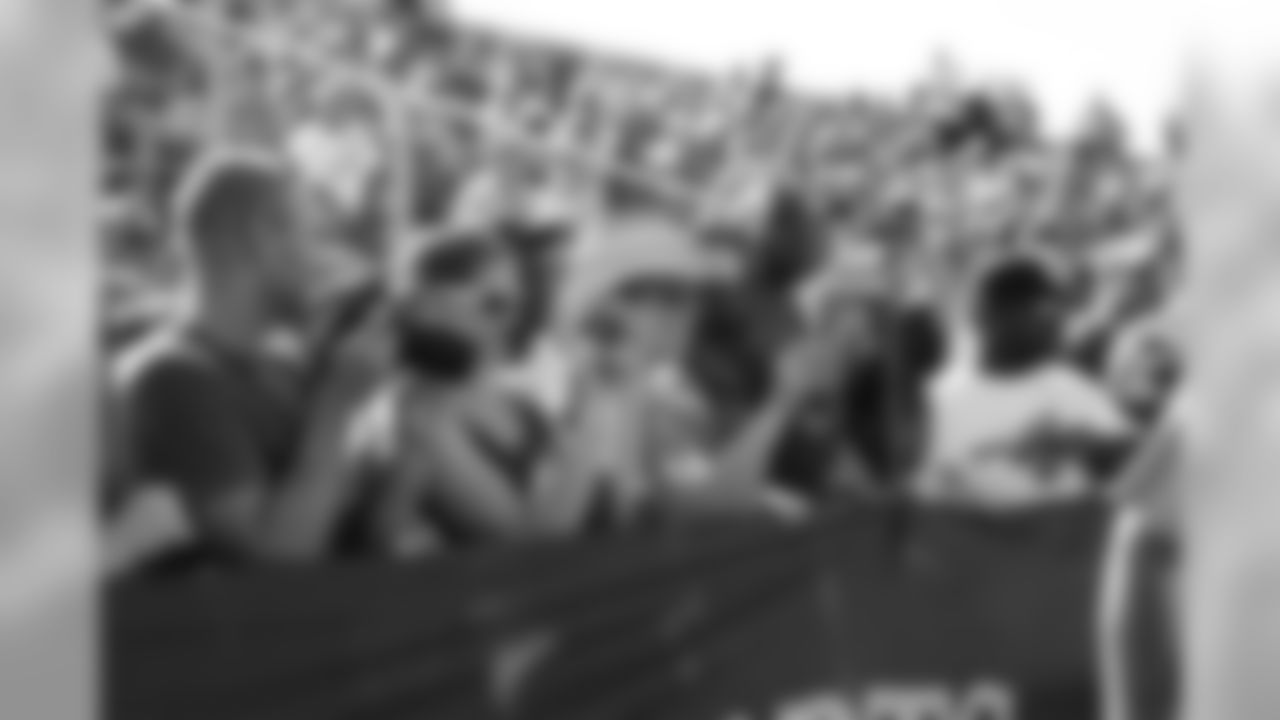Fans take pictures from the stands