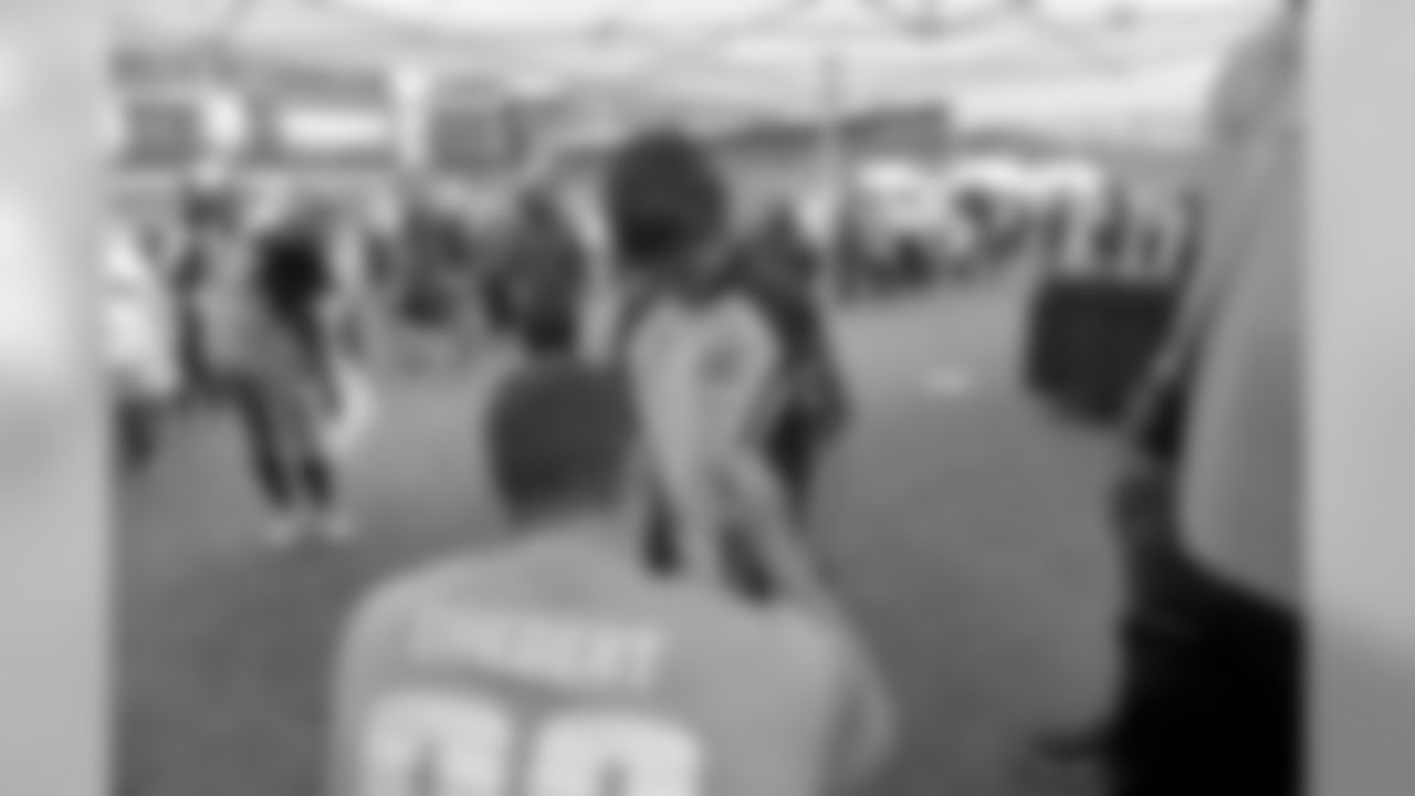 TE Dallas Goedert signs an autograph for a young fan.