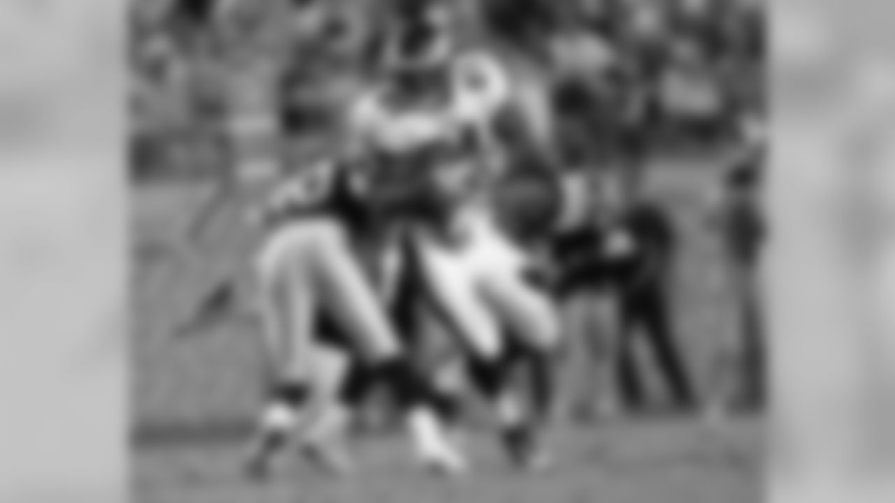 WR Jason Avant tries to break free of tacklers