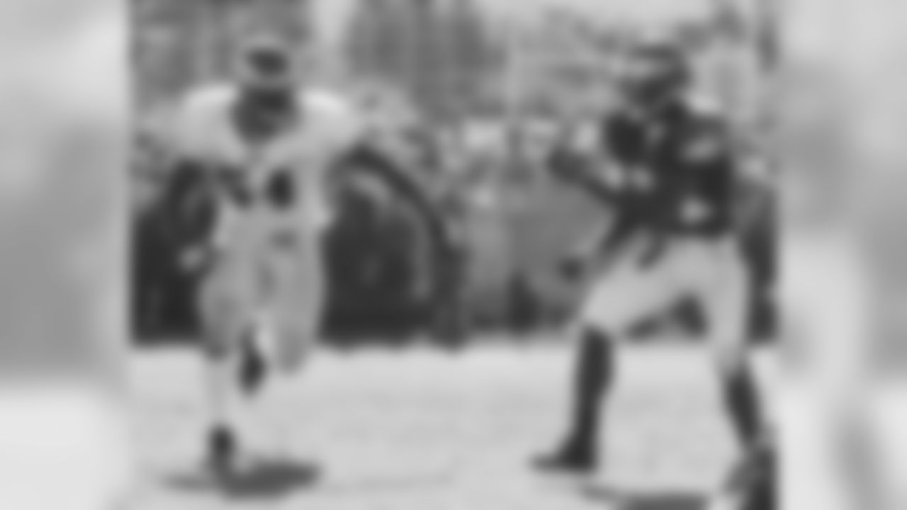 Linebacker Jeremiah Trotter passes wide receiver Jason Avant