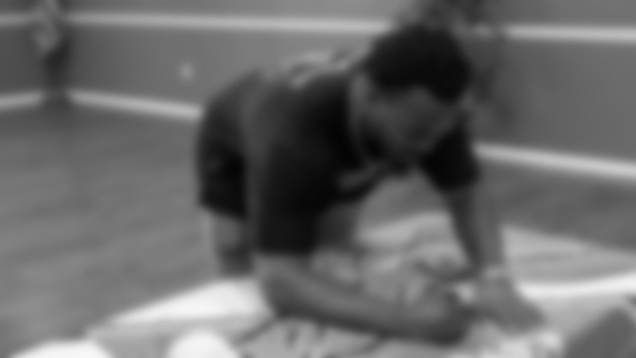 Dean signs a retro Eagles flag.