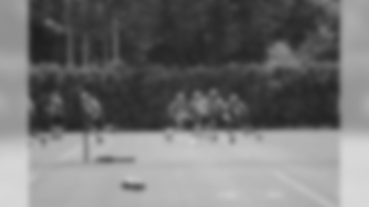QBs and RBs work during a drill
