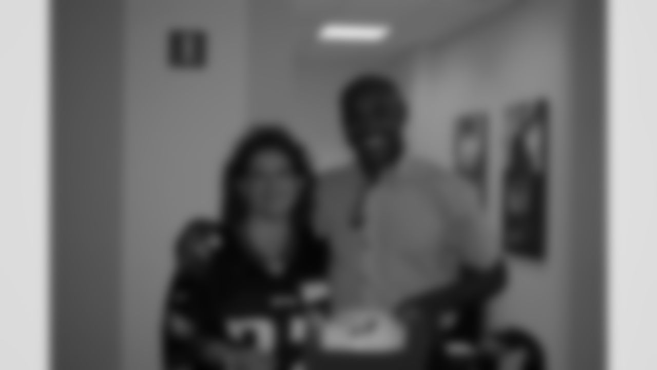 Fred stands with lucky winner of a Jason Peters signed football