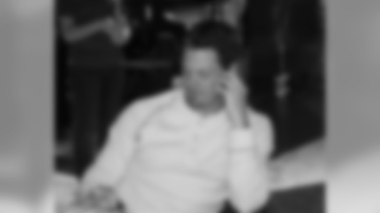 Kevin Kolb talks on a fans phone to their grandmother, a die-hard Eagles supporter who could not attend the event