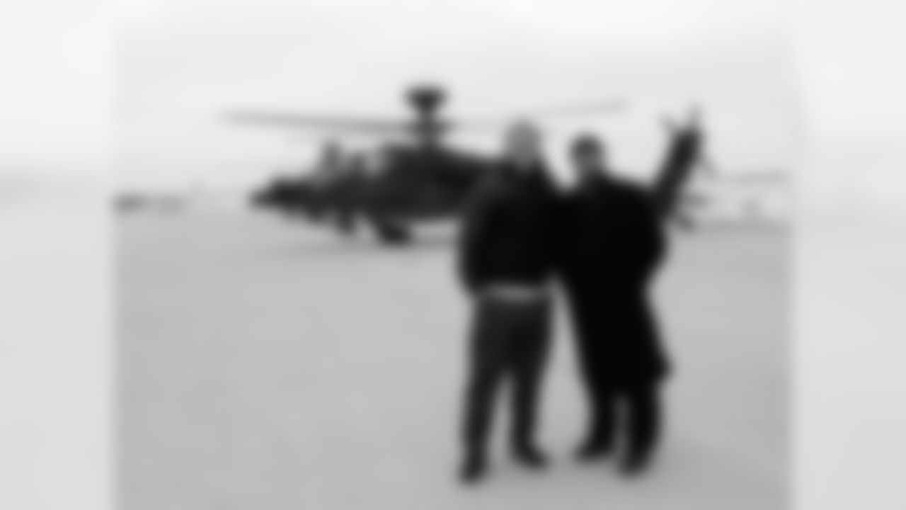 QB Matt Barkley and LS Jon Dorenbos pose in front of an Apache helicopter