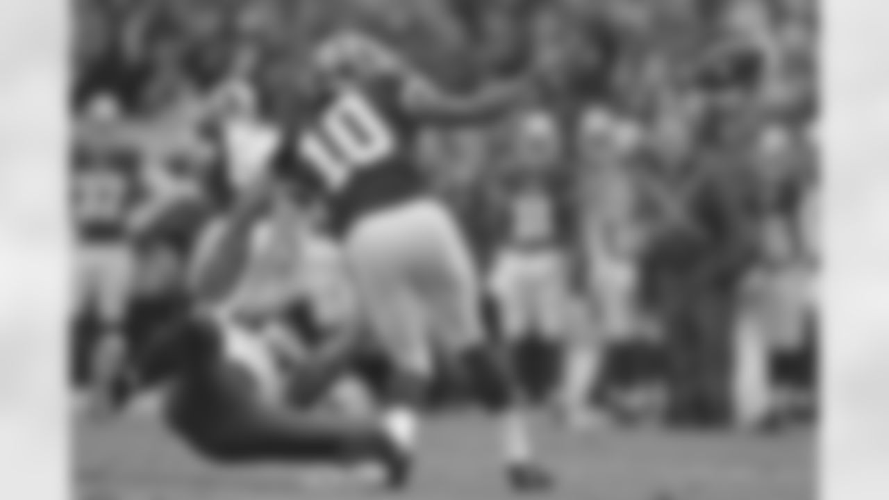 QB Robert Griffin III gets rid of the ball before being brought down for a sack