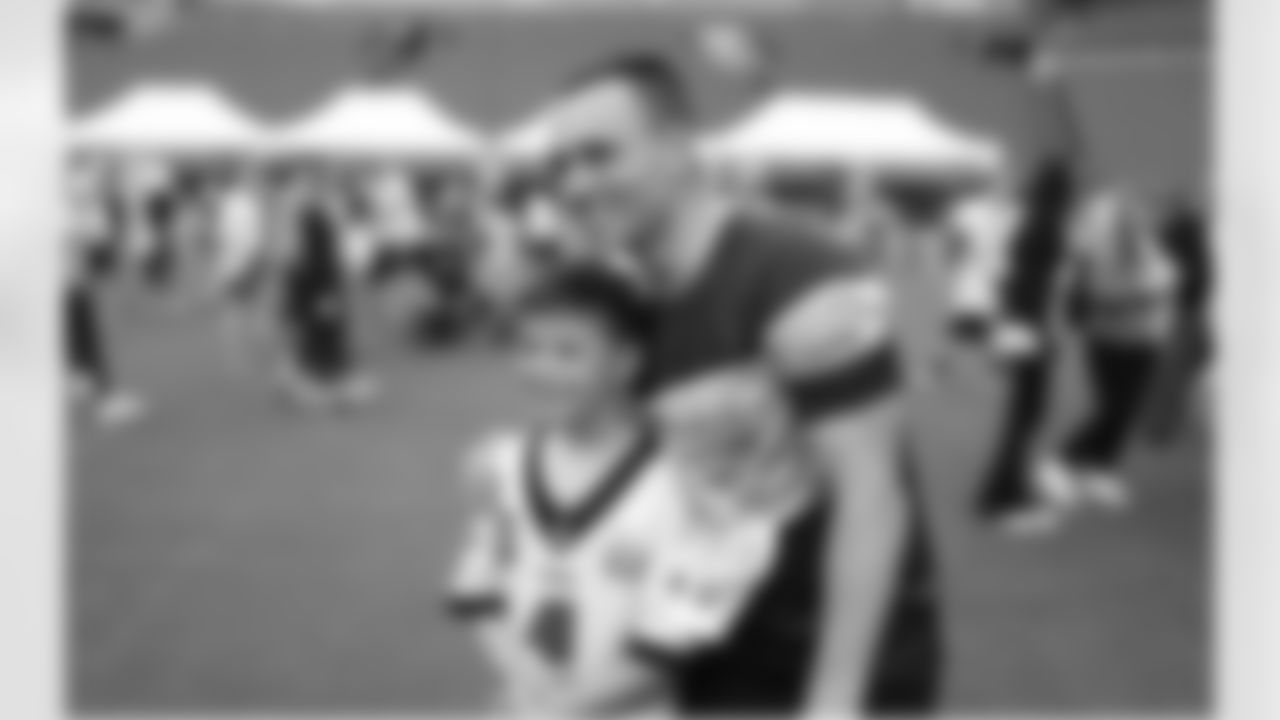 WR Britain Covey taking a photo with Eagles Autism Challenge participant