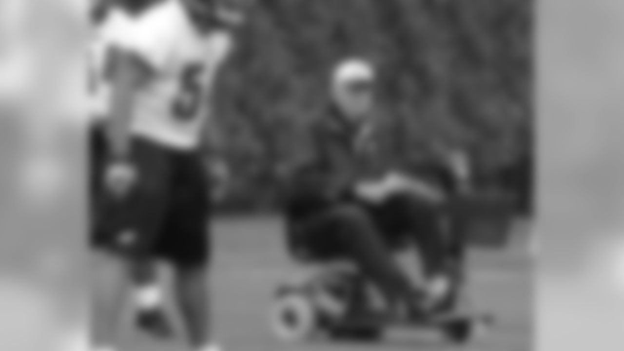 Defensive coordinator Jim Johnson runs defensive drills from a motorized cart