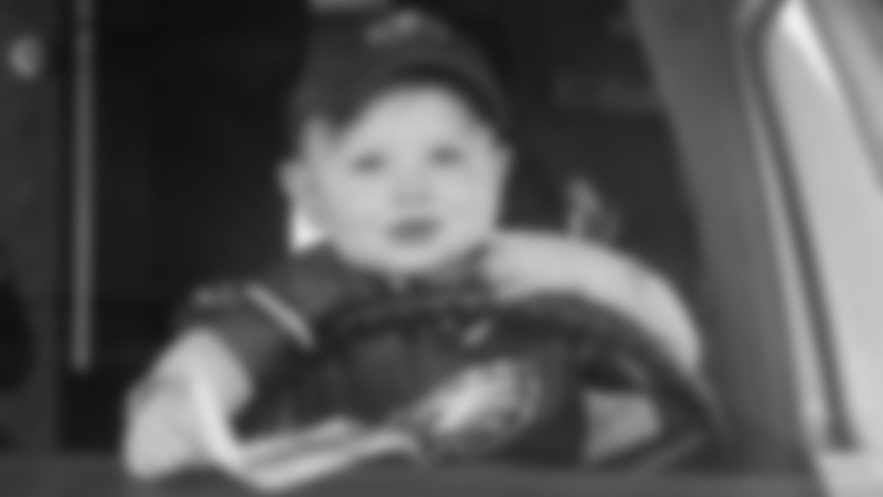 A young Eagles fan sits in the drivers seat of a vehicle before the week two game agaisnt the Chargers.