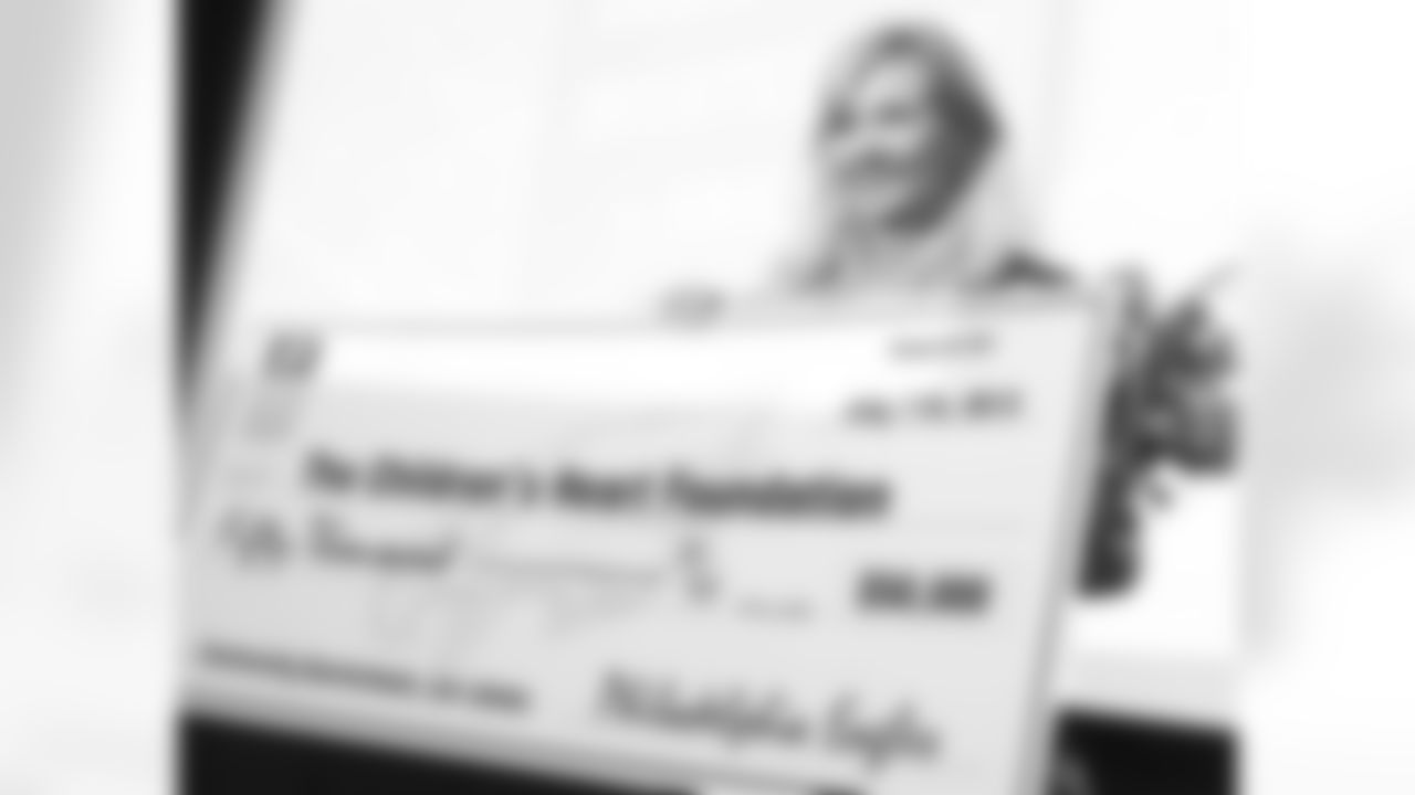 Lori Jones holds the check for $50,000. Jones' work with the charity started when her daughter, Riley, was diagnosed before birth with a congential heart defect